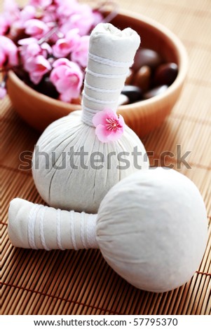 two massage stamps with bowl of stones - beauty treatment