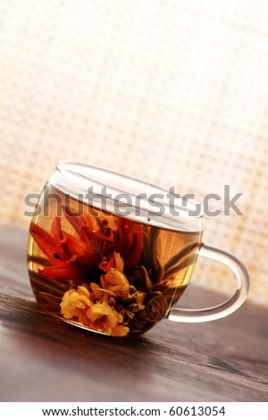glass of white tea with beauty tea flower inside - tea time