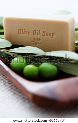 bar of organic olive oil soap with branch of olives - beauty treatment