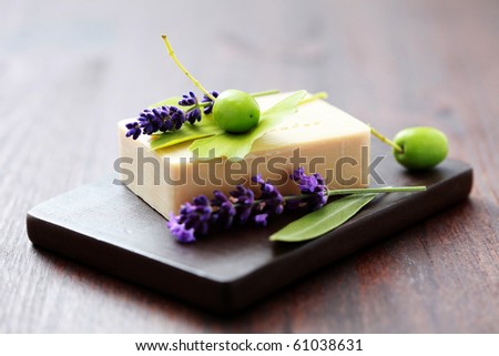 bar of herbal soap with fresh herbs and olives - beauty treatment