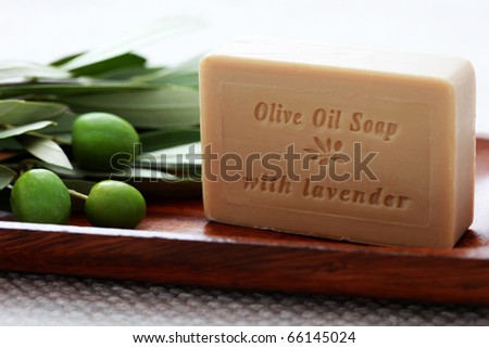 bar of organic olive oil soap with branch of olives - beauty treatment