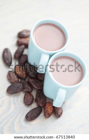 cup of hot cocoa with cocoa beans - food and drink