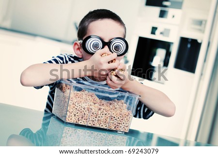 8 years old boy eating cereals - kids and family