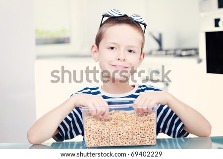 8 years old boy eating cereals - kids and family