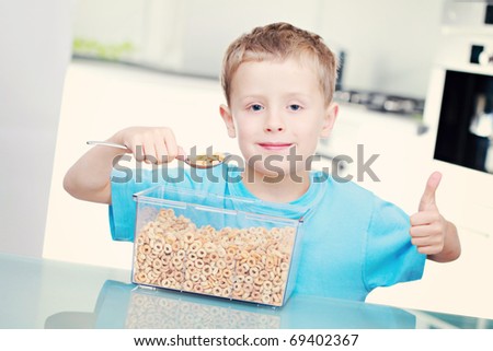 6 years old boy eating cereals - kids and family