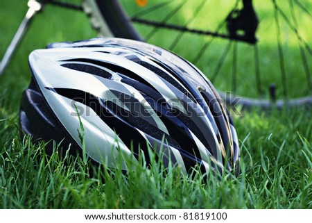 bicycle helmet on green grass - sport and leisure