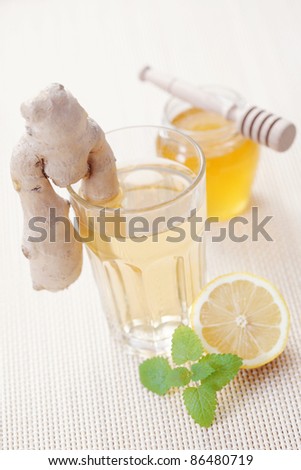 glass of ginger tea with honey and lemon - tea time