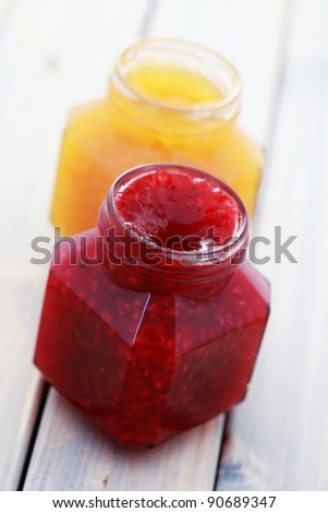 jar of orange and raspberry jam - food and drink