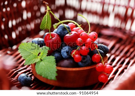 bowl of delicious berry fruits with fresh mint - fruits and vegetables
