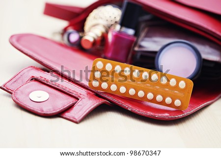 birth control pill in handbag - healthcare and medicine