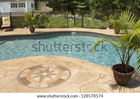 Luxury salt water pool and patio in a residential backyard.