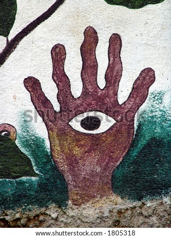 Primitive wall mural of hand with eye