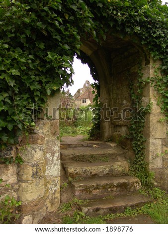 Steps going up through old garden archway