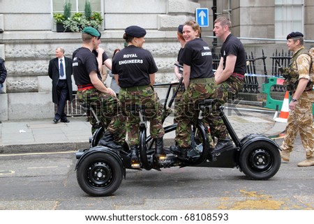CITY OF LONDON, ENGLAND - NOVEMBER 12: Military women engineers ride strange vehicle at the Lord Mayor\'s Show on November 12, 2010 in the City of London. The Lord Mayor\'s Show is an annual parade.