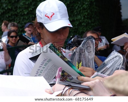 WIMBLEDON, ENGLAND, JUNE 24: Rapha Nadal signing autographs for fans at the Wimbledon Lawn Tennis Championship in Wimbledon, England on June 24, 2010. Rapha Nadal went on to win the championship