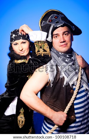 actors in a suits of the pirates near the map and treasures  on a blue background