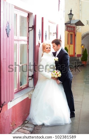 beautiful groom and the bride on the street of old Tallinn