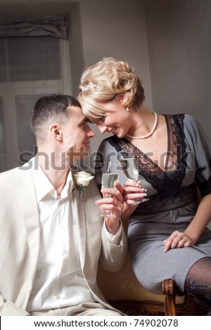 Happy bride and groom in bedroom interior
