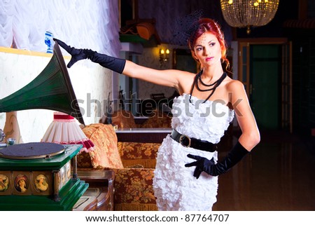 Portrait of beautiful sexy young woman wearing black and white in vintage hall interior