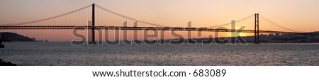 Panorama of bridge 25 de Abril on river Tagus at sunset, Lisbon, Portugal