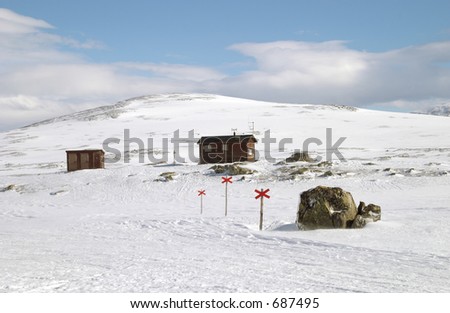 Cross country ski hiking trail with red crosses a mountain hut, Lapland north Sweden