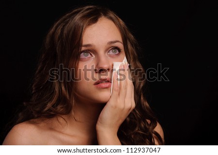 close up portrait of sad woman isolated on black