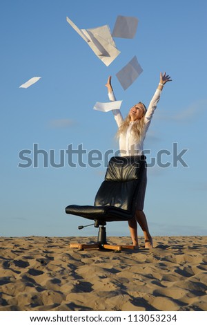 business woman stand near armchair and scatter paper