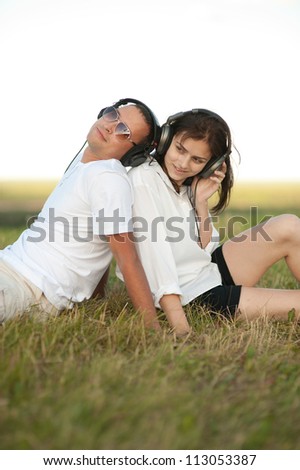 Happy young couple listening to music together