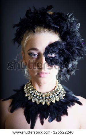 portrait of sexy woman with black feather half mask for Venice desire concept