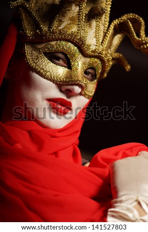 closeup portrait of sexy woman in golden theater mask for desire concept
