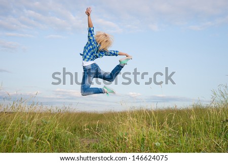 Professional gymnast woman jump in green grass field