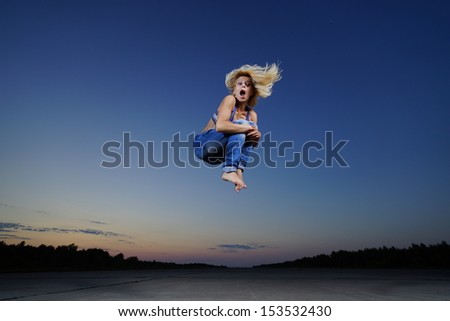 Professional gymnast woman jump at night