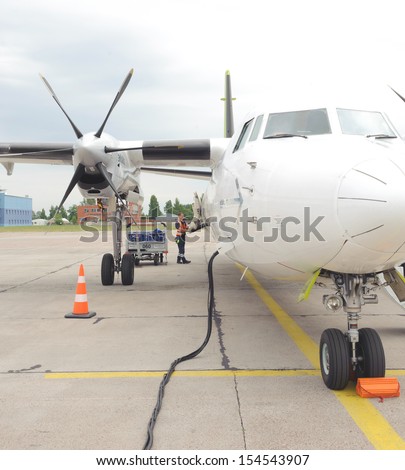 RIGA, LATVIA - JUNE 16, 2011: Air Baltic propeller airplane in Riga airport. Air Baltic is the Latvian flag carrier airline and a low-cost carrier. June 16, 2011 in Riga, Latvia.