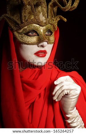 closeup portrait of sexy woman in golden theater mask for desire concept