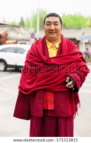 BEIJING- APRIL 28: Unidentified Monk posing on street on April 2013 in Beijing, China. Buddhist schools vary on the exact nature of the path to liberation
