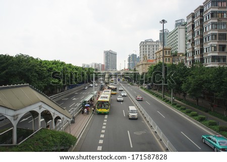 GUANGZHOU, CHINA-MAY 15: buses and cars at roads of Guangzhou on May 15, 2013 in Guangzhou, China. Guangzhou  is the capital and largest city of Guangdong province, People\'s Republic of China