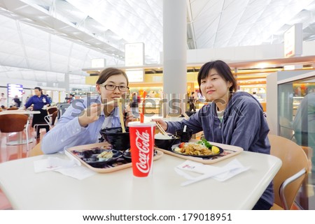 HONG KONG, CHINA - APRIL 11, 2010: Korean girl eat Japanese food in Hong Kong International Airport on April 11, 2010 in Hong Kong, China. The one of the best airport in the annual passenger survey by Skytrax.