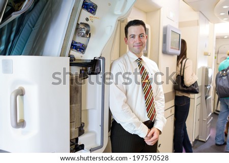 HONG KONG -JUNE 04: Emirates crew member meet passengers in Airbus A380 on June 04, 2014 in Hong Kong, China. Emirates handles major part of passenger traffic and aircraft movements at the airport.