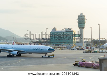 HONG KONG - APRIL 17: control tower and Cathay Pacific jet flight on April 17, 2014 in Hong Kong. Cathay Pacific is the international flag carrier of Hong Kong