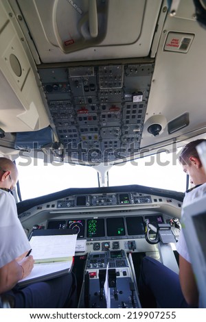 GENEVA - SEPTEMBER 16: Etihad Regional pilots in aircraft cockpit on September 16, 2014 in Geneva, Switzerland. Darwin Airline, operating under the brand name Etihad Regional since January 2014