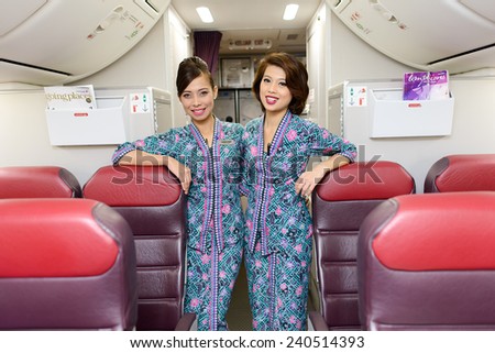 HONG KONG, CHINA - MAY 12, 2014: Malaysian Airline crew members posing in Boeing 737 aircraft after landing on MAY 12, 2014. Malaysian Airline System is the flag carrier airline of Malaysia