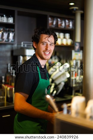 PARIS - SEPTEMBER 09: Starbucks cafe barman on September 09, 2014 in Paris, France. Starbucks is the largest coffeehouse company in the world, with more then 23000 stores