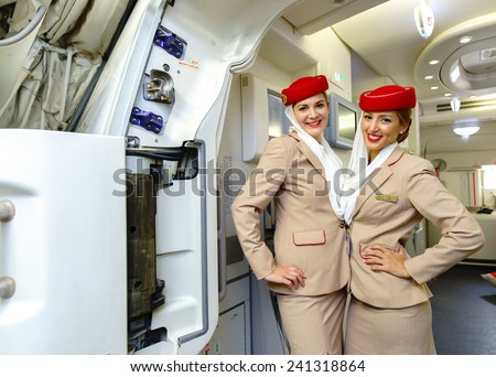 DUBAI - OCT 17: Emirates crew members meet passengers in Airbus A380 aircraft on October 17, 2014 in Dubai, UAE. Emirates handles major part of passenger traffic and aircraft movements at the airport.