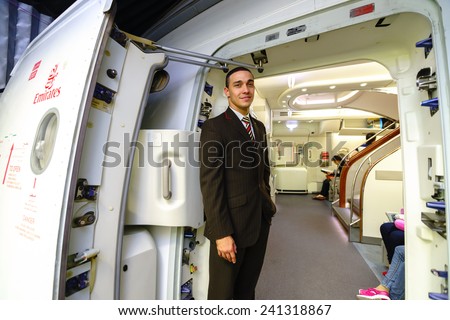 DUBAI - OCT 17: Emirates crew member meet passengers in Airbus A380 aircraft on October 17, 2014 in Dubai, UAE. Emirates handles major part of passenger traffic and aircraft movements at the airport.