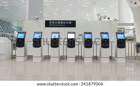 SHENZHEN - APRIL 16: self check-in kiosks on April 16, 2014 in Shenzhen, China. Shenzhen Bao\'an International Airport is located near Huangtian and Fuyong villages in Bao\'an District, Shenzhen