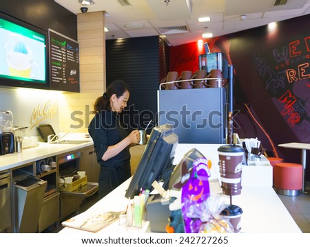 SHENZHEN - NOV 06: woman making coffee latte on November 06, 2014 in Shenzhen, China. The McDonald\'s Corporation is the world\'s largest chain of hamburger fast food restaurants