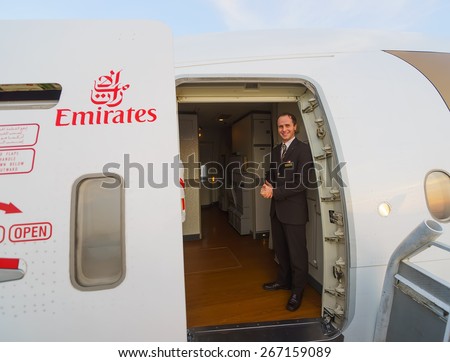 DUBAI, UAE - MARCH 31, 2015: Emirates crew member of Boeing-777. Emirates is one of two flag carriers of the United Arab Emirates along with Etihad Airways and is based in Dubai.