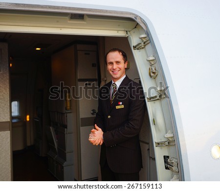 DUBAI, UAE - MARCH 31, 2015: Emirates crew member of Boeing-777. Emirates is one of two flag carriers of the United Arab Emirates along with Etihad Airways and is based in Dubai.