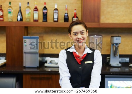 DUBAI, UAE - APRIL 07, 2013: Emirates business lounge staff. Emirates is one of two flag carriers of the United Arab Emirates along with Etihad Airways and is based in Dubai.