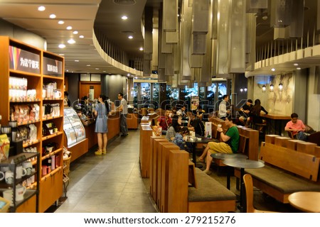 SHENZHEN, CHINA - MAY 17, 2015: Starbucks cafe interior. Starbucks Corporation is an American global coffee company and coffeehouse chain based in Seattle, Washington